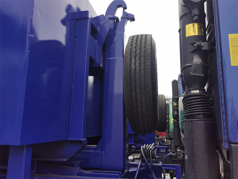 Hooklift truck with spare tire installed